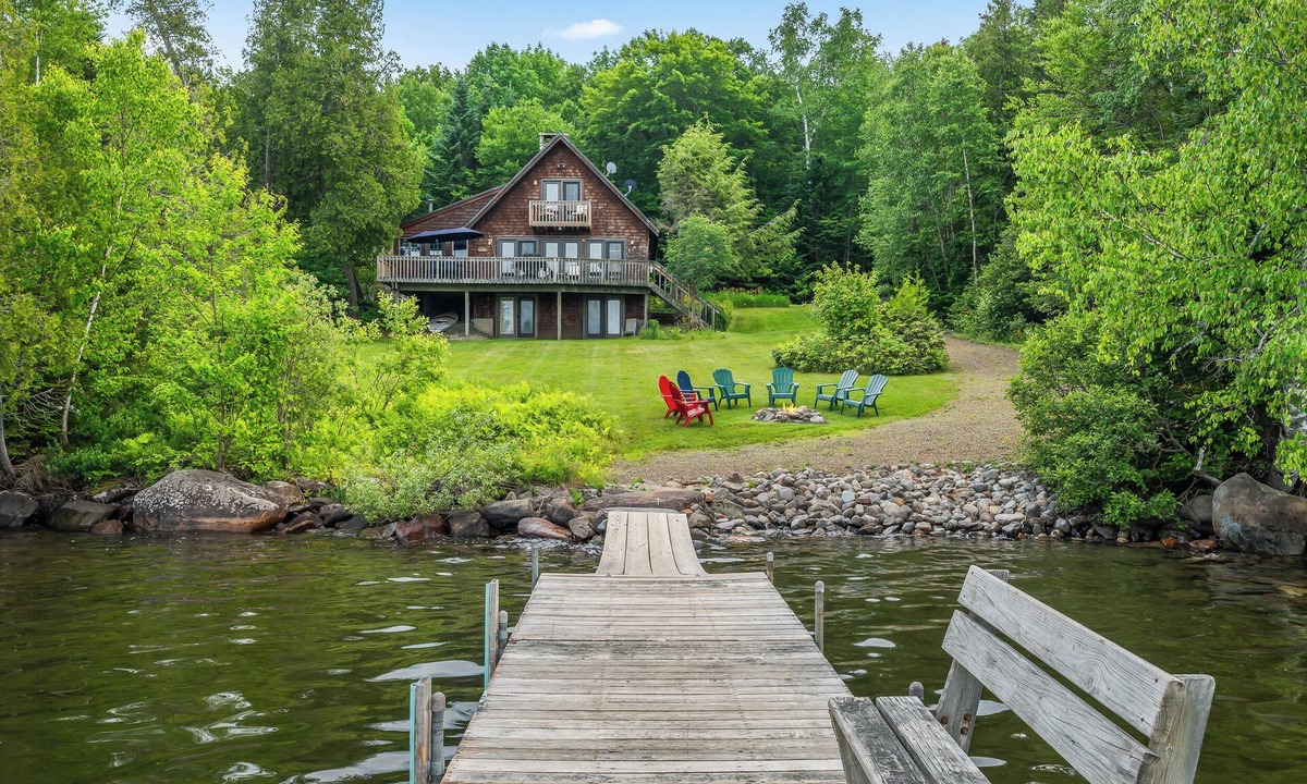 Rangeley Plantation House | Stone - This Rangeley Lake home has a very level entry to the water with a huge deck!