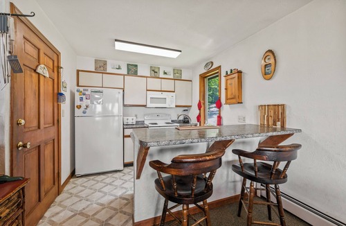 Rangeley Plantation House | Stone - This Rangeley Lake home has a very level entry to the water with a huge deck!