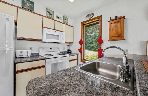 Rangeley Plantation House | Stone - This Rangeley Lake home has a very level entry to the water with a huge deck!
