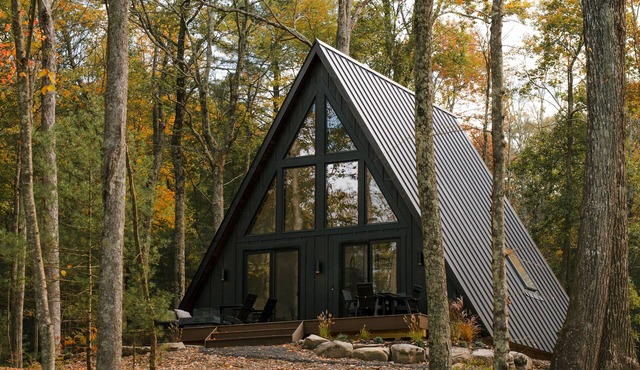 A modern A-frame, nestled in the woods with relaxing outdoor spaces and firepit.