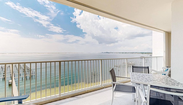Waterfront condo with beach access, pools, balcony, central AC, & W&D